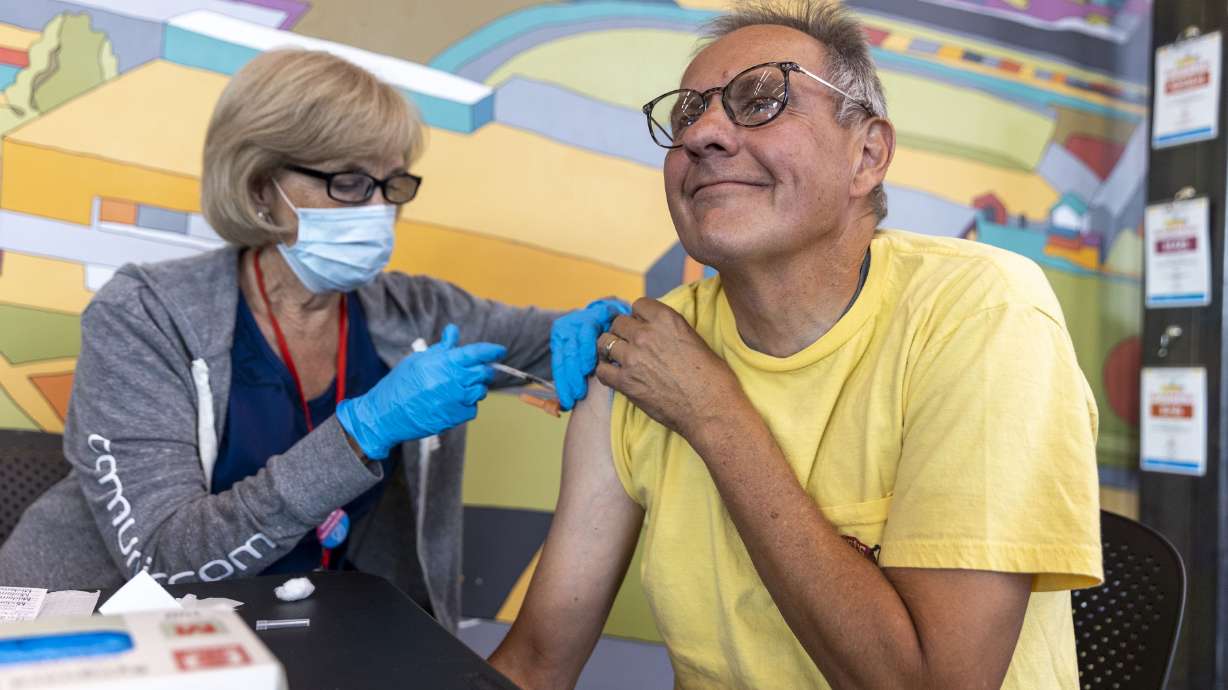 Nurse Cathy Martin administers a COVID-19 booster to Steve Pfeiffer at the Kearns Library in Kearns on Sept. 29. More than 116,000 Utahns have already received the updated COVID-19 booster shot, according to data provided by the Utah Department of Health and Human Services.