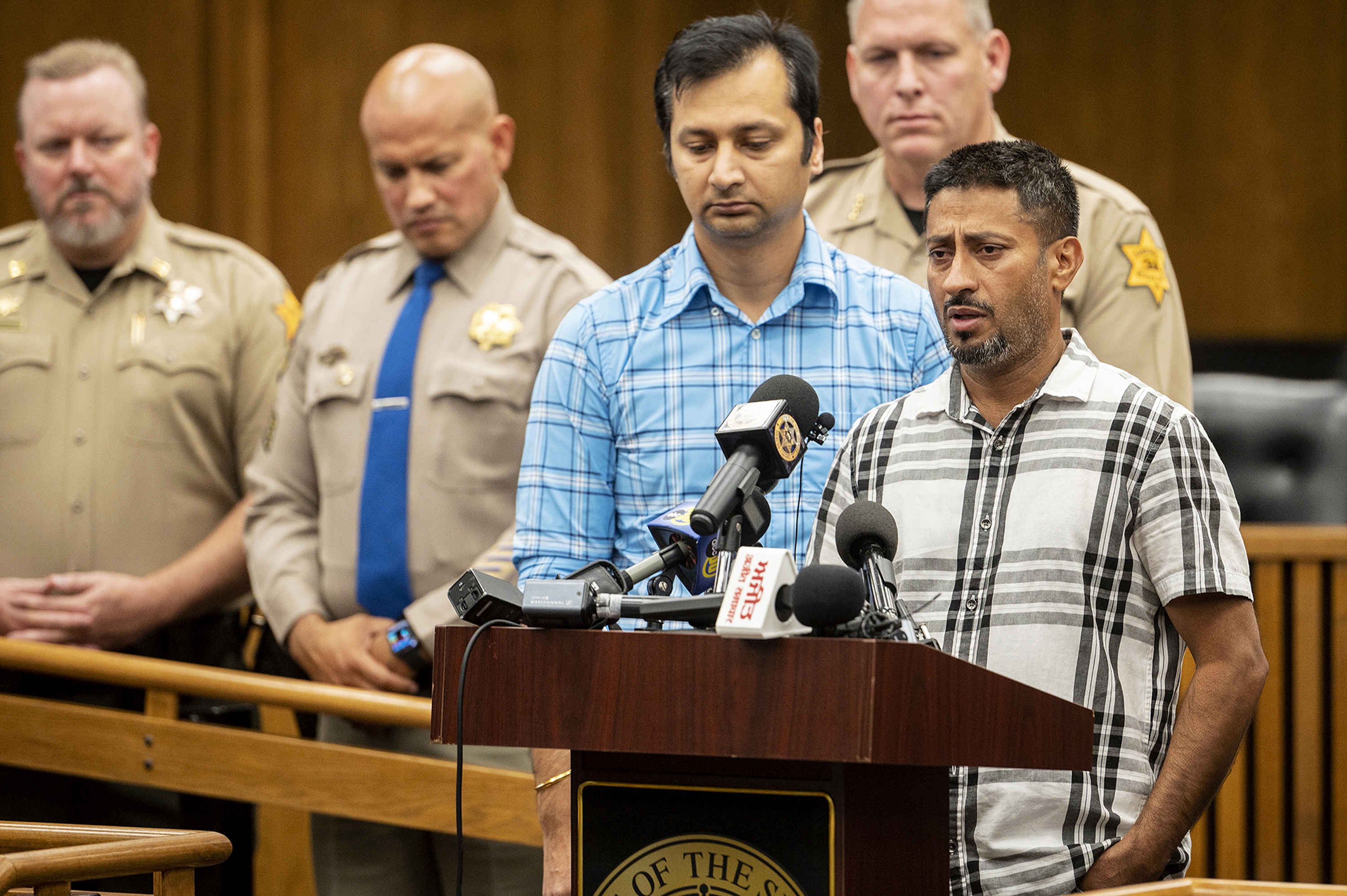 Sukhdeep Singh, right, and Balwinder Saini, middle, speak about the kidnapping of their family members, 8-month-old Aroohi Dheri, her mother Jasleen Kaur, her father Jasdeep Singh, and her uncle Amandeep Singh at a news conference in Merced, Calif., on Wednesday.