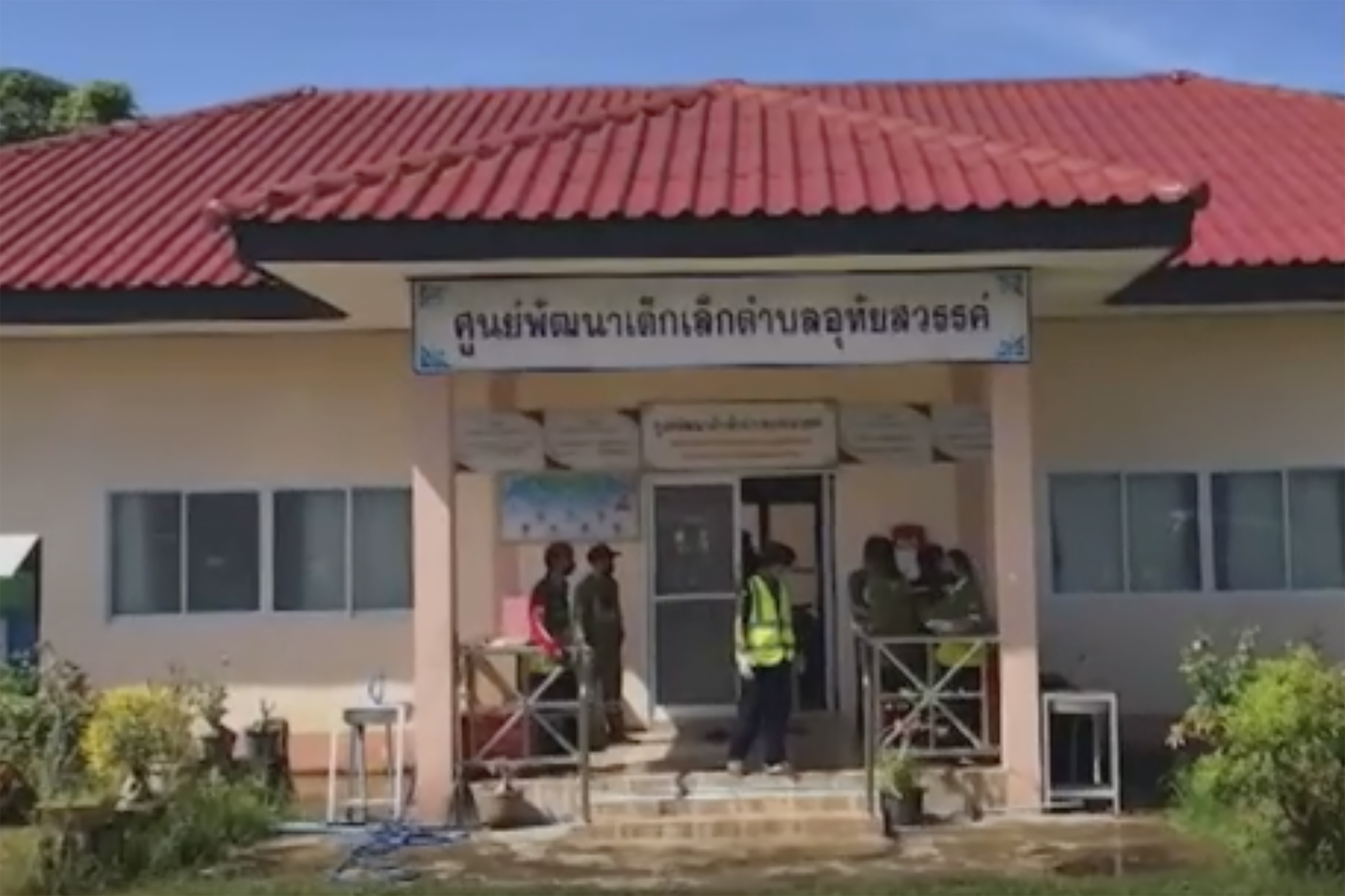 Officials enter the site of an attack at a day care center, Thursday in Nongbua Lamphu, northeastern Thailand. More than 30 people, primarily children, were killed Thursday when a gunman opened fire at the child care center.