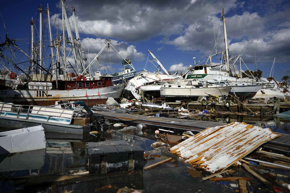 Shrimp boats that came from further down the coast sit atop the remains of a mobile home park, Wednesday, on San Carlos Island, Fort Myers Beach, Fla., one week after the passage of Hurricane Ian.