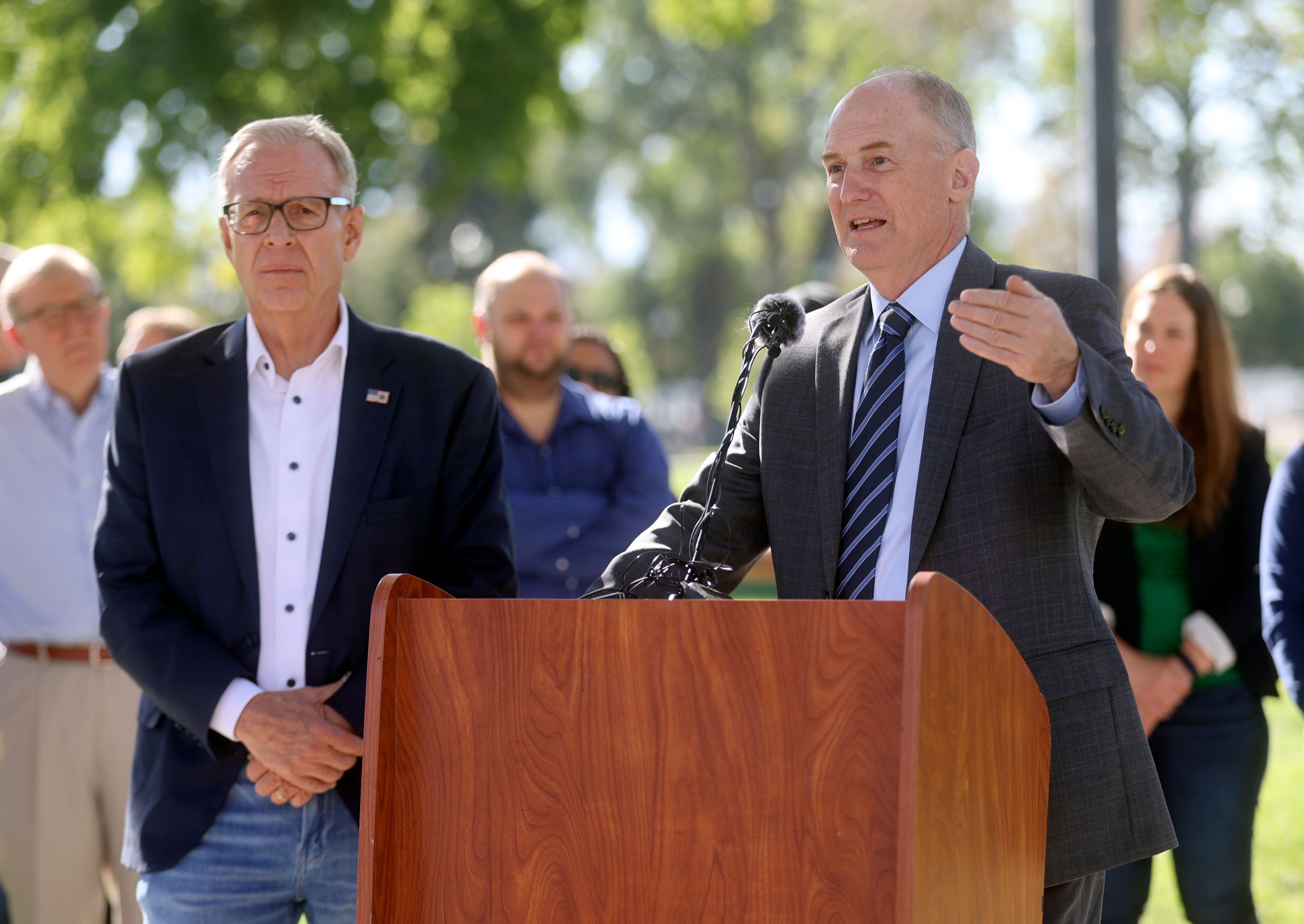 Scott Howell, Pioneer Park Coalition board member and former Utah State legislator, listens as Jim Behunin, PPC executive director and former Utah legislative auditor general, speaks about proposed homelessness solutions during a press conference in Pioneer Park in Salt Lake City on Thursday.