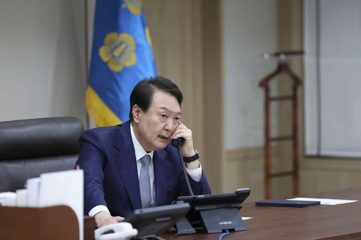 South Korean President Yoon Suk Yeol talks on the phone with Japanese Prime Minister Fumio Kishida in Seoul, South Korea, Thursday. South Korean President Yoon Suk Yeol and Japanese Prime Minister Fumio Kishida spoke by phone Thursday and agreed that North Korea's recent missile tests are "a serious, grave provocation" that threatens international peace.