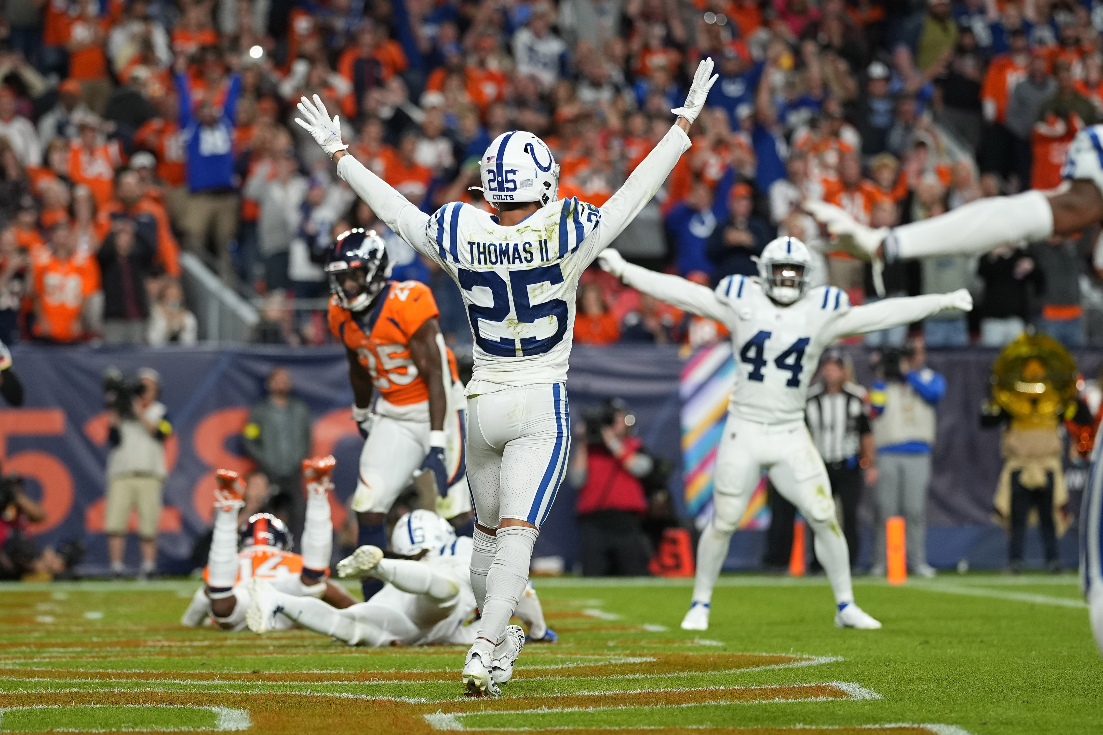 Indianapolis Colts safety Rodney Thomas II (25) and linebacker Zaire Franklin (44) celebrate after an NFL football game against the Denver Broncos, Thursday, Oct. 6, 2022, in Denver. The Colts defeated the Broncos 12-9 in overtime. 