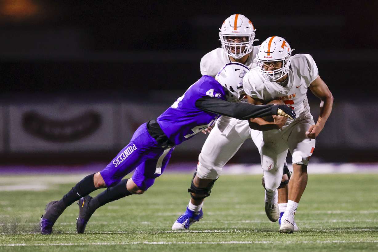Quezon Villa (6) of the Timpview Thunderbirds runs the ball while being tackled by Gavin Fenn (46) of The Lehi Pioneers in Lehi on Thursday, Oct. 6, 2022. Lehi won 28-24.