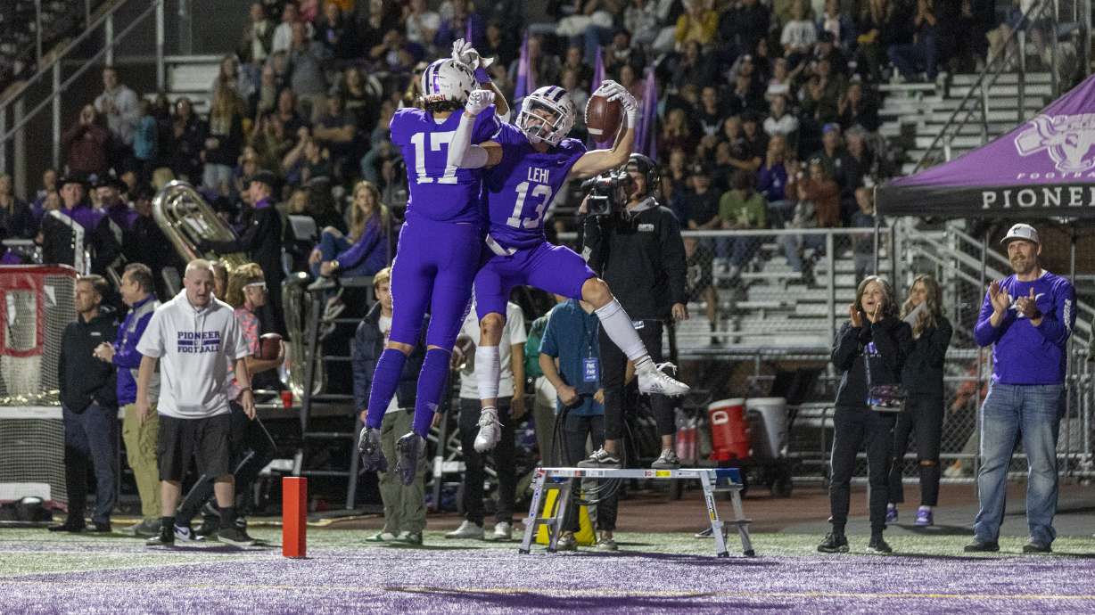 Makafefie Havea (17) and Kolton Tanner (13) of the Lehi Pioneers celebrate after scoring a touchdown against the Timpview Thunderbirds in Lehi on Thursday, Oct. 6, 2022. Lehi won 28-24.