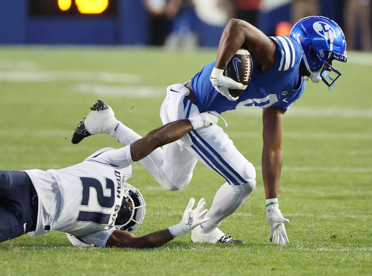 Brigham Young wide receiver Kody Epps (0) runs against Utah State cornerback Andre Grayson (21) in Provo on Thursday, Sept. 29, 2022.