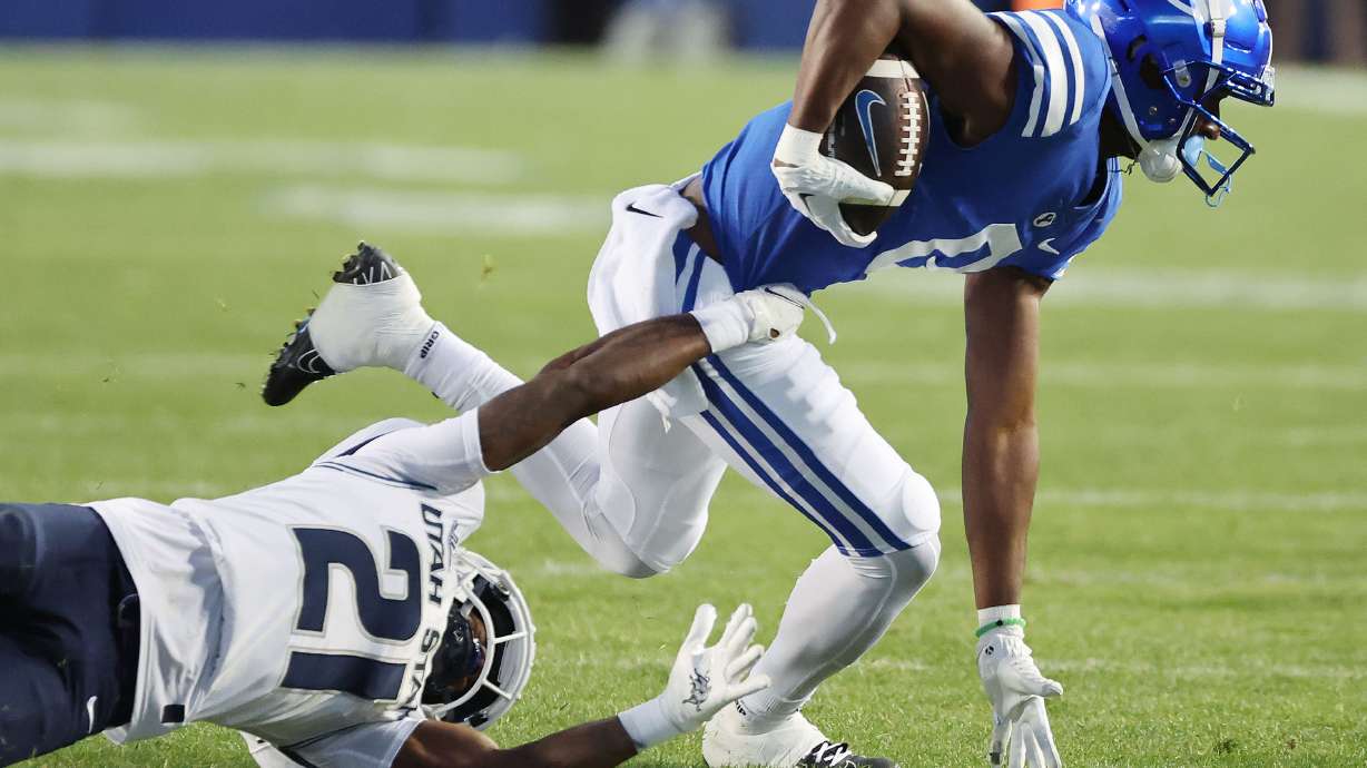 Brigham Young wide receiver Kody Epps (0) runs against Utah State cornerback Andre Grayson (21) in Provo on Thursday, Sept. 29, 2022.