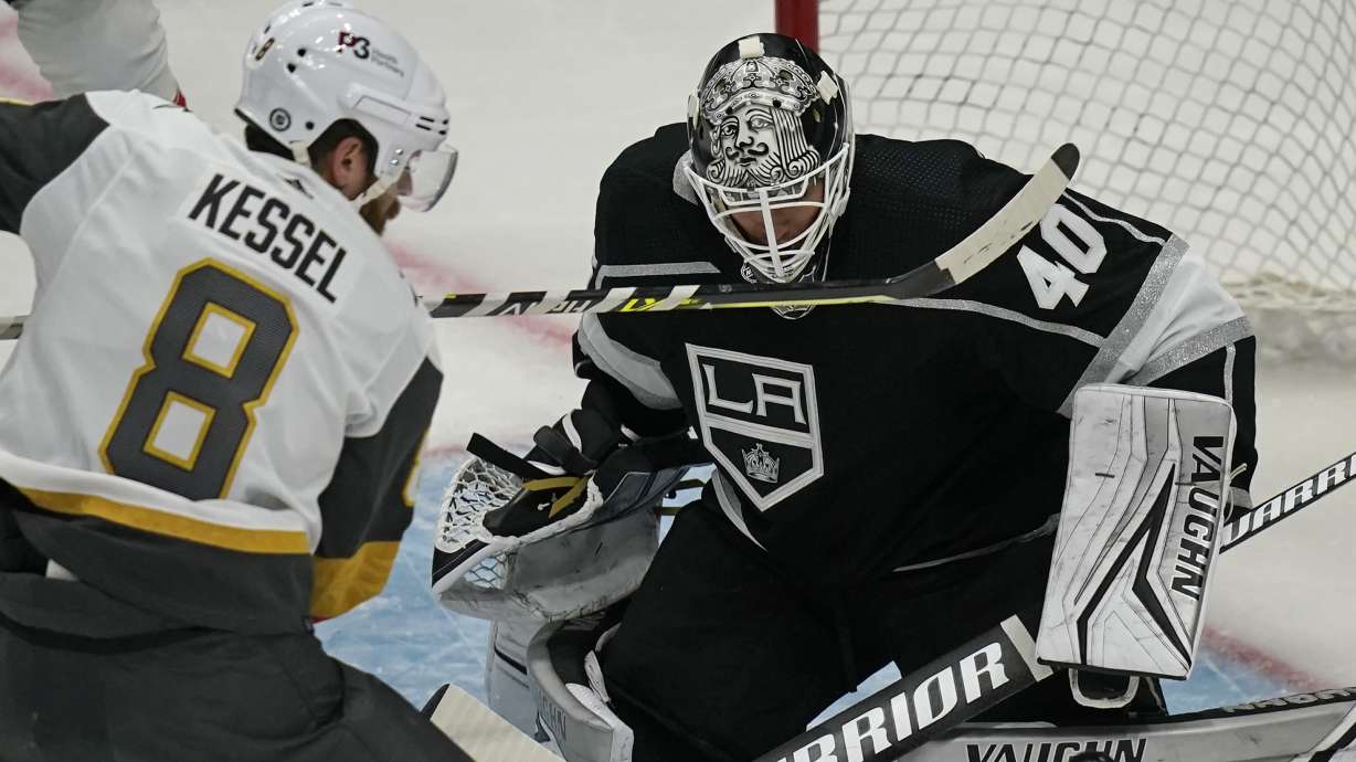 Los Angeles Kings goaltender Cal Petersen (40) makes a save as Vegas Golden Knights center Phil Kessel (8) looks on during the third period of an NHL preseason hockey game Thursday, Oct. 6, 2022, in Salt Lake City.