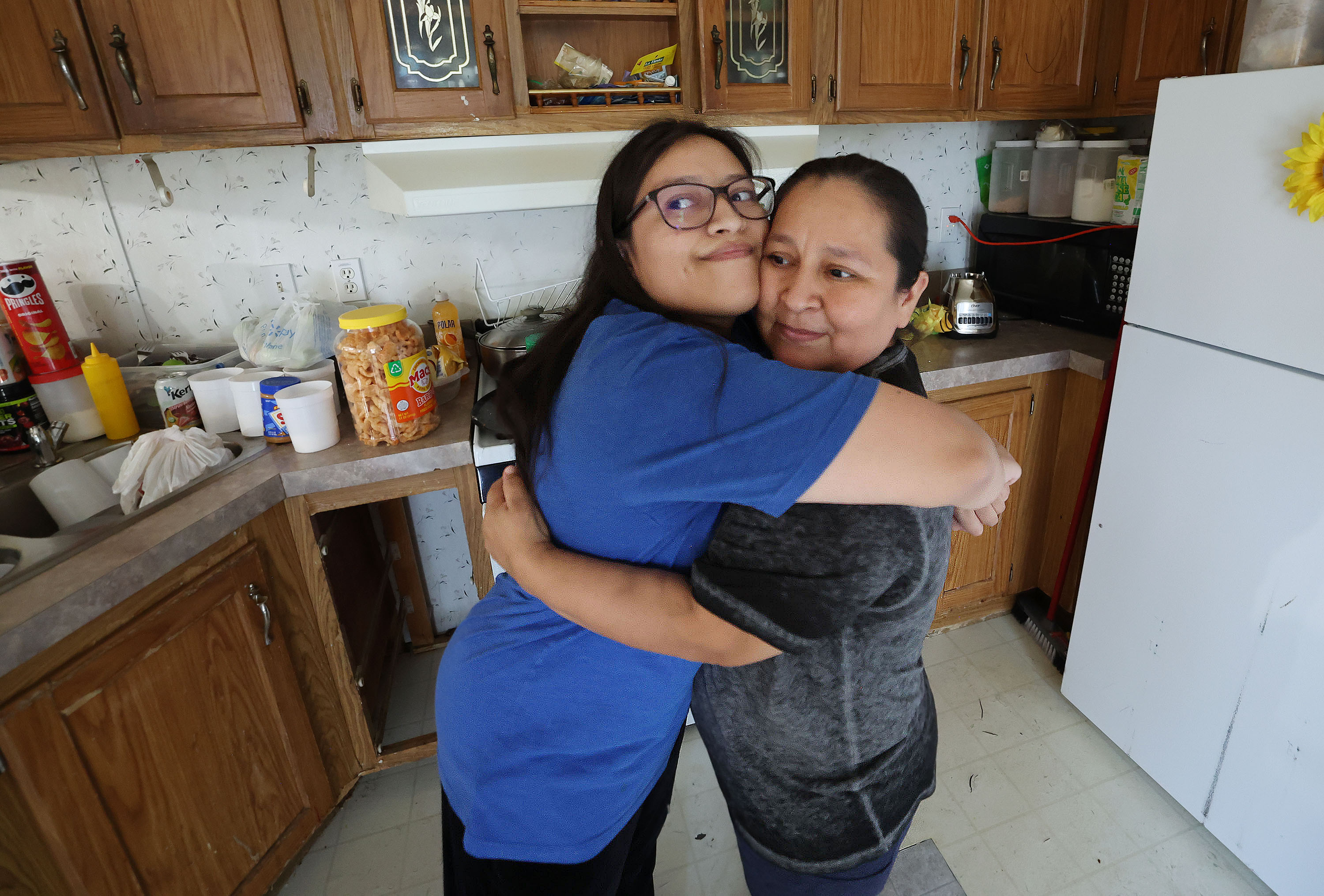 Susana Estrada hugs her oldest daughter, Alexandra Ledesma, at their trailer park home in Provo on Wednesday. Estrada and her family are immigrants, including five children who are disabled. They were going to lose their home until the Fuller Center for Housing of Utah County stepped in to help with repairs.
