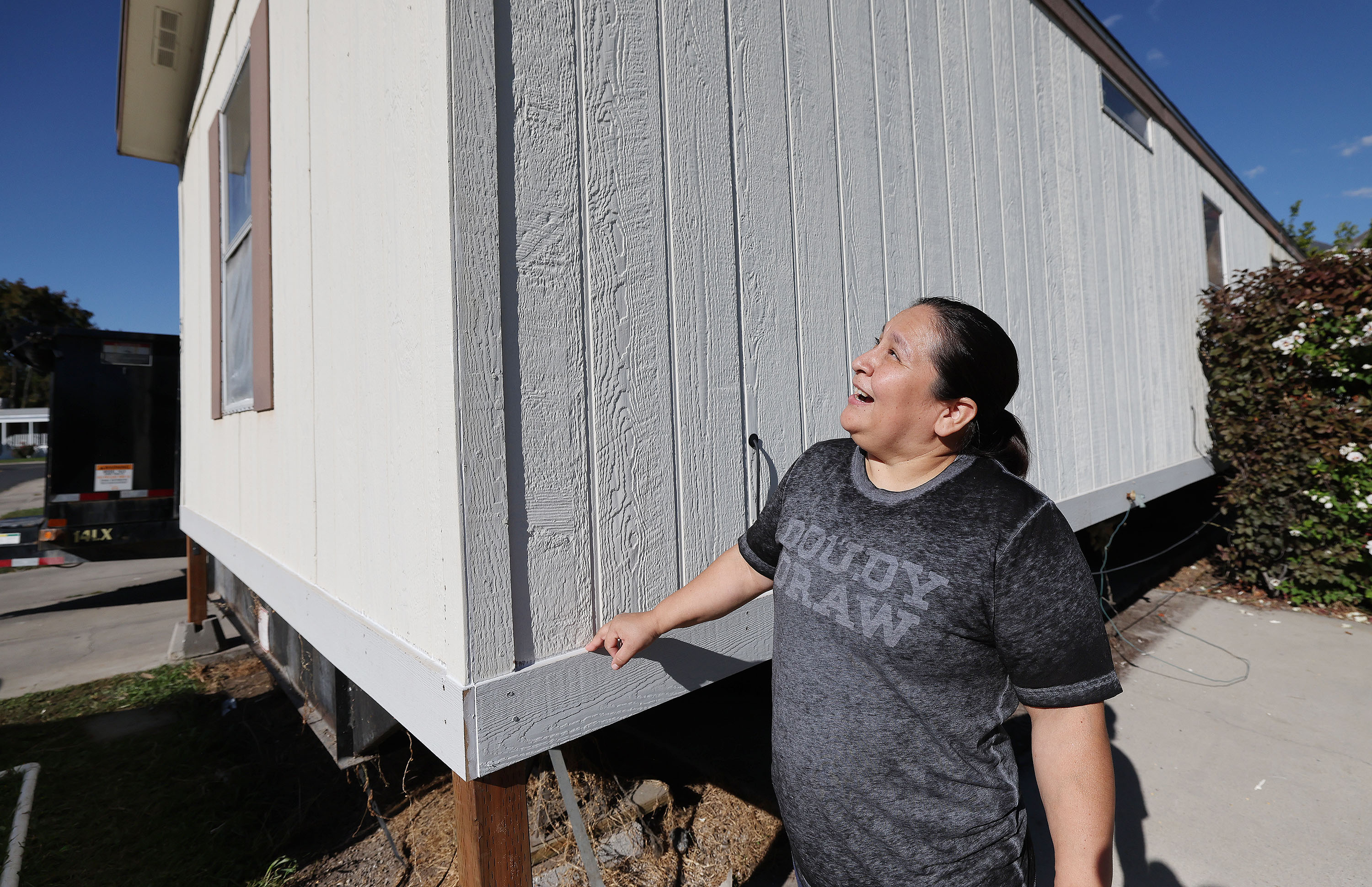Susana Estrada talks about her new roof at her trailer park home in Provo on Wednesday. Estrada and her family are immigrants including five children who are disabled. They were going to lose their home until the Fuller Center for Housing of Utah County stepped in to help with repairs.