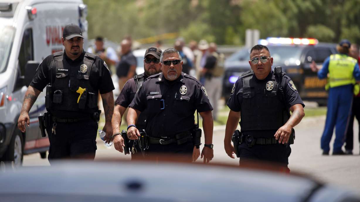 Police walk near Robb Elementary School following a shooting May 24 in Uvalde, Texas. Four months after the Robb Elementary School shooting, the Uvalde school district on Friday pulled its entire embattled campus police force off the job.