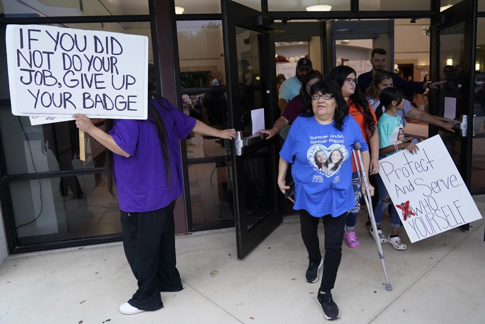 Family, parents and friends file out of a meeting where Uvalde School District Police Chief Pete Arredondo was dismissed by the Board of Trustees of the Uvalde Consolidated Independent School District, Aug. 24 in Uvalde, Texas. Four months after the Robb Elementary School shooting, the Uvalde school district on Friday pulled its entire embattled campus police force off the job.