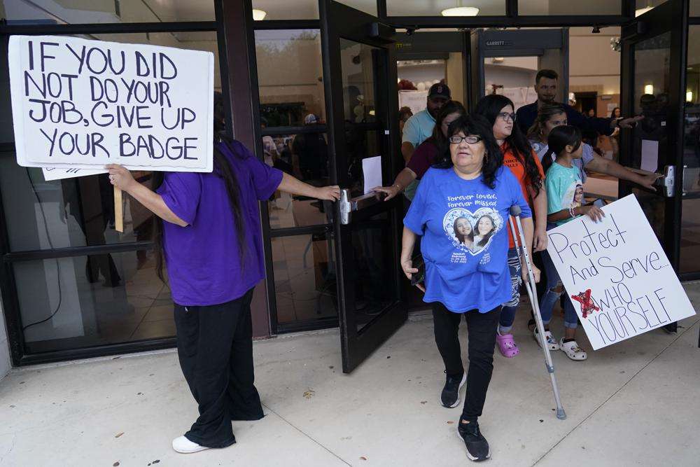 Family, parents and friends file out of a meeting where Uvalde School District Police Chief Pete Arredondo was dismissed by the Board of Trustees of the Uvalde Consolidated Independent School District, Aug. 24 in Uvalde, Texas. Four months after the Robb Elementary School shooting, the Uvalde school district on Friday pulled its entire embattled campus police force off the job.