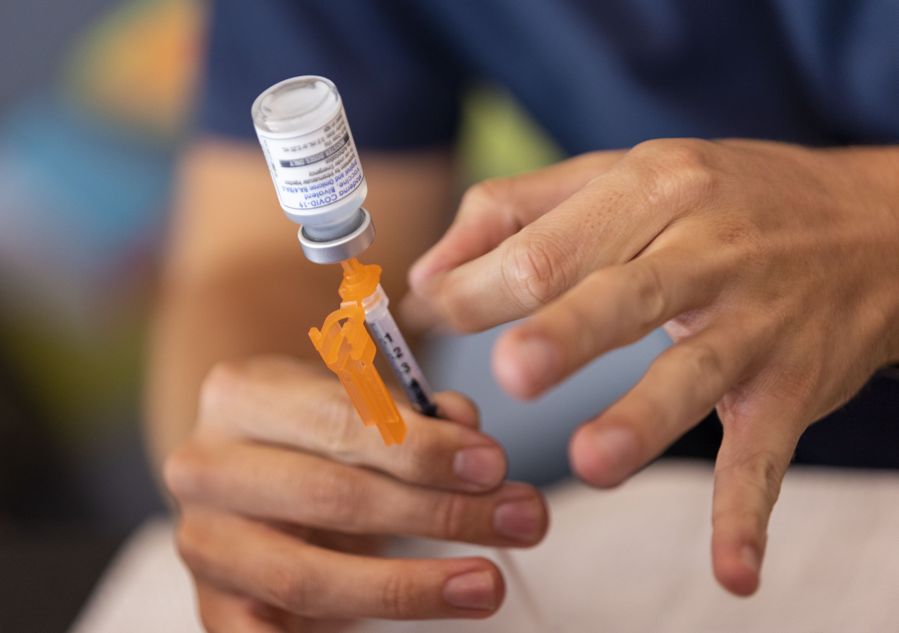 Nurse Aydan Elzinga prepares a COVID-19 booster shot at the Kearns Library in Kearns on Sept. 29. Republicans are dying at a higher rate from COVID-19 than Democrats, new research suggests.