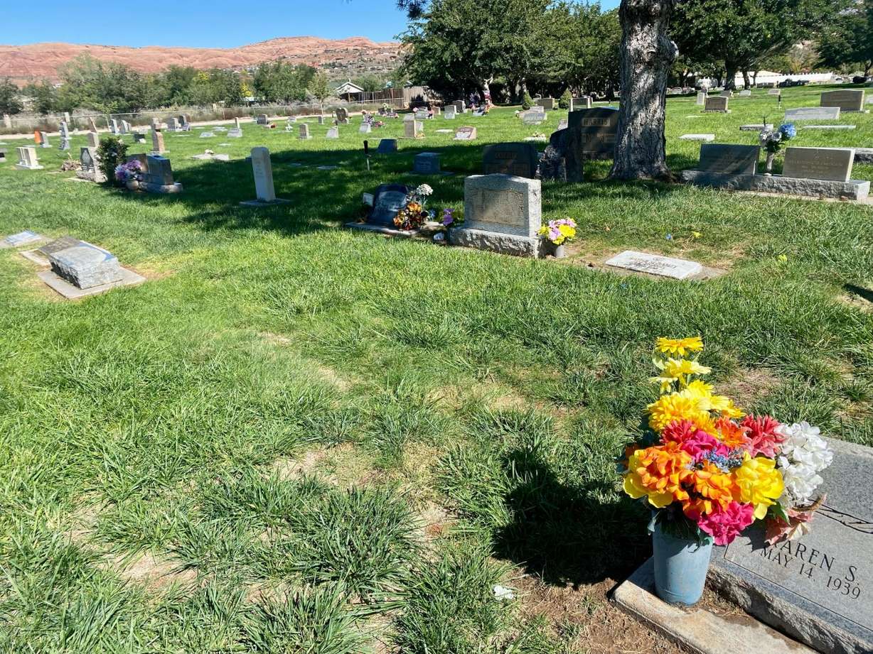 The remains of an unidentified body found shot to death in Arches National Park in 1983 are buried under a patch of grass in the Sunset Memorial Gardens Cemetery in Moab on Friday, Oct. 7, 2022. There is no headstone to mark the site. Provo police are trying to figure out if the body belongs to a teen who went missing in Provo 40 years ago.