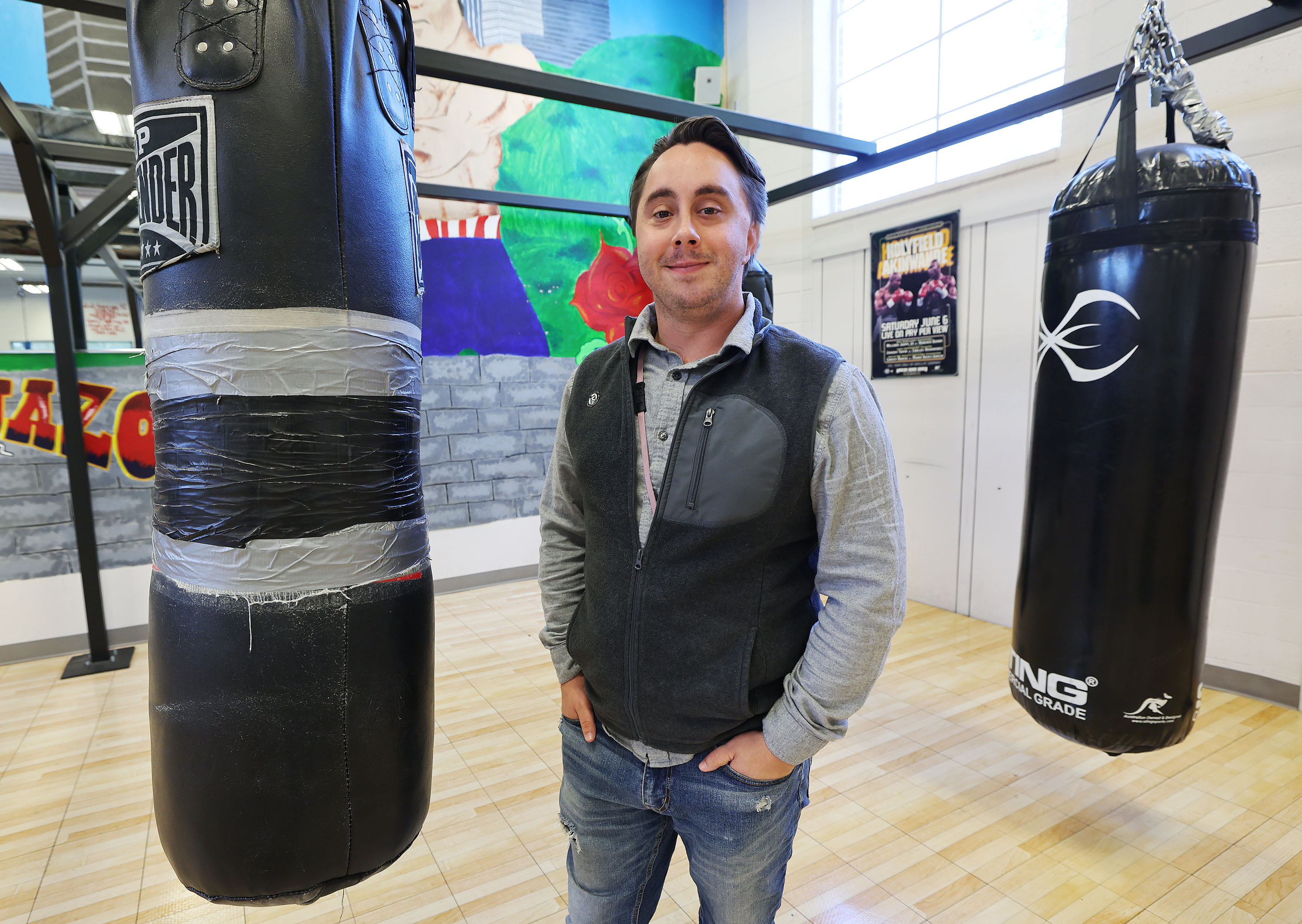Patrick Holman, South Salt Lake City's Central Park Community Center/PAL Boxing coordinator, stands in the boxing gym in South Salt Lake on Friday. A new Dan Jones & Associates poll asked Utahns whether they approve of the Biden administration's student loan forgiveness initiative. Holman is a University of Phoenix student who benefited.