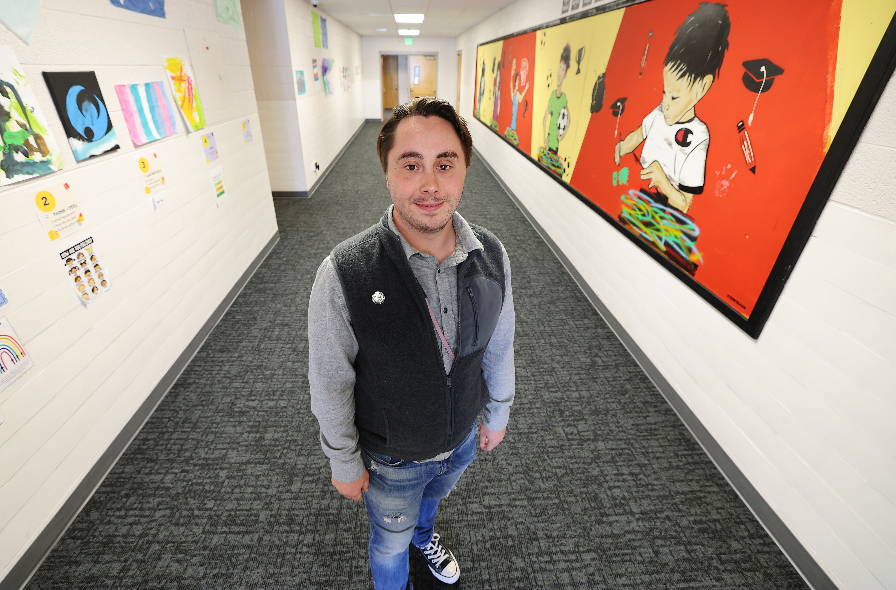Patrick Holman, South Salt Lake City's Central Park Community Center/PAL Boxing coordinator, stands in the center in South Salt Lake on Friday. A new Dan Jones & Associates poll asked Utahns whether they approve of the Biden administration's student loan forgiveness initiative. Holman is a University of Phoenix student who benefited.