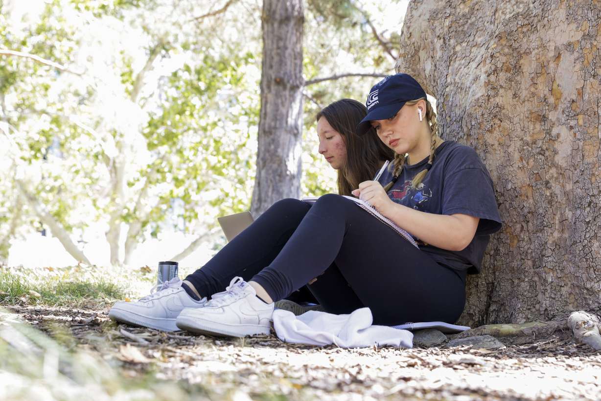 Sophomore Gaelen Kinkead, right, sits next to her friend and fellow sophomore Ashlay Findley on the University of Utah campus in Salt Lake City on Sept. 19.