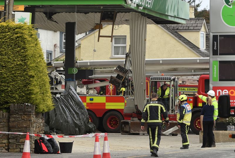 Emergency services attend the scene of a explosion, resulting in multiple deaths, at a service station in the village of Creeslough, in County Donegal, Ireland, Saturday.