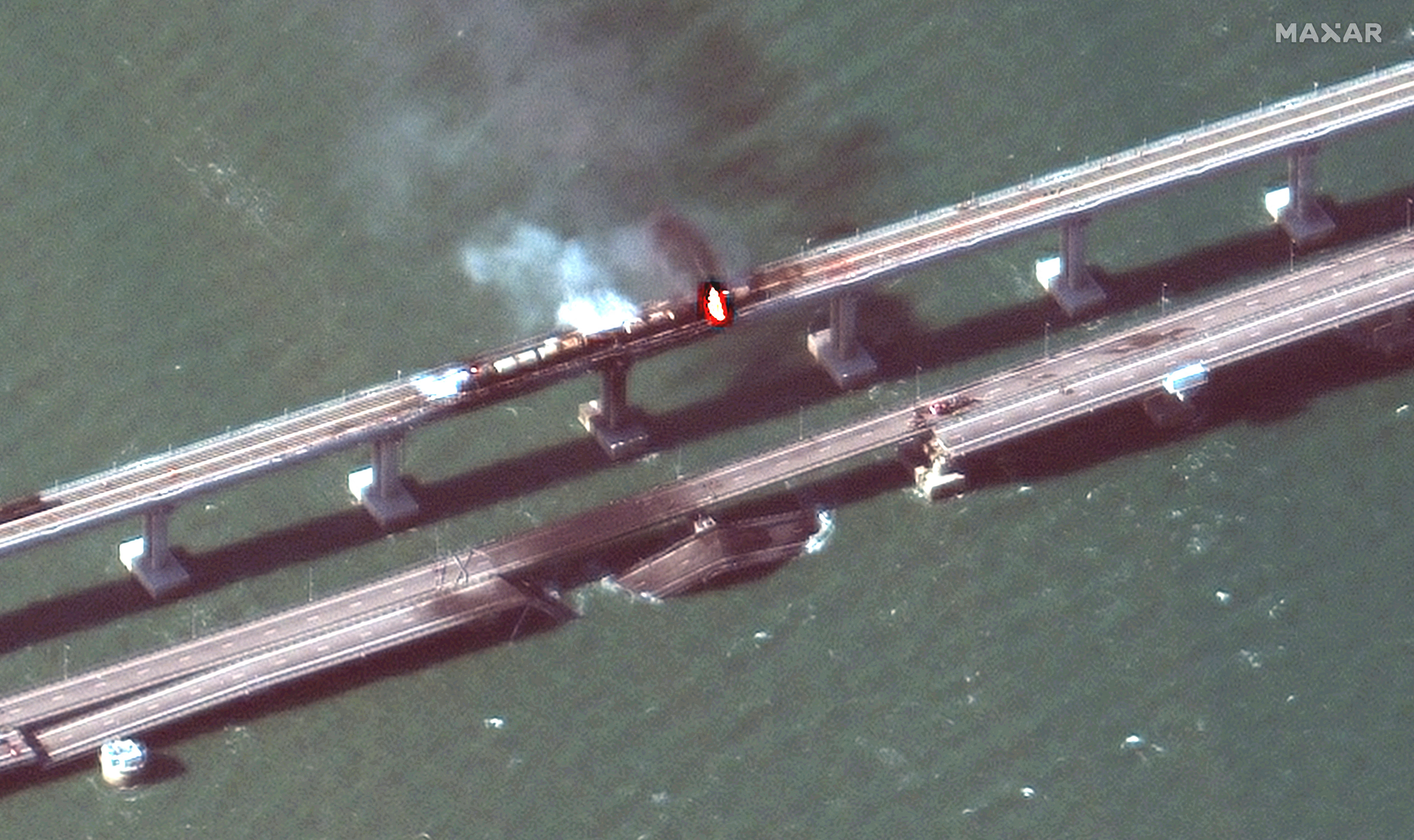 A satellite image shows a close up view of smoke rising from a fire on the Kerch bridge in the Kerch Strait, Crimea, Saturday.