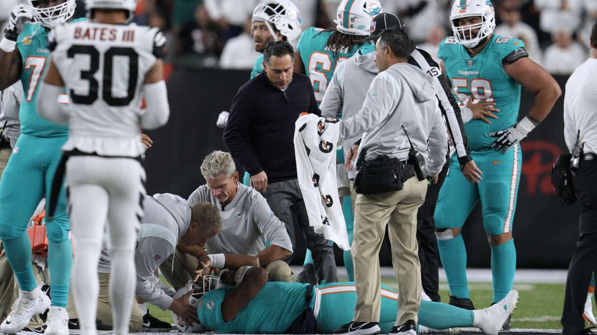 Miami Dolphins quarterback Tua Tagovailoa is examined during the first half of the team's NFL football game against the Cincinnati Bengals, Thursday, Sept. 29, 2022, in Cincinnati.