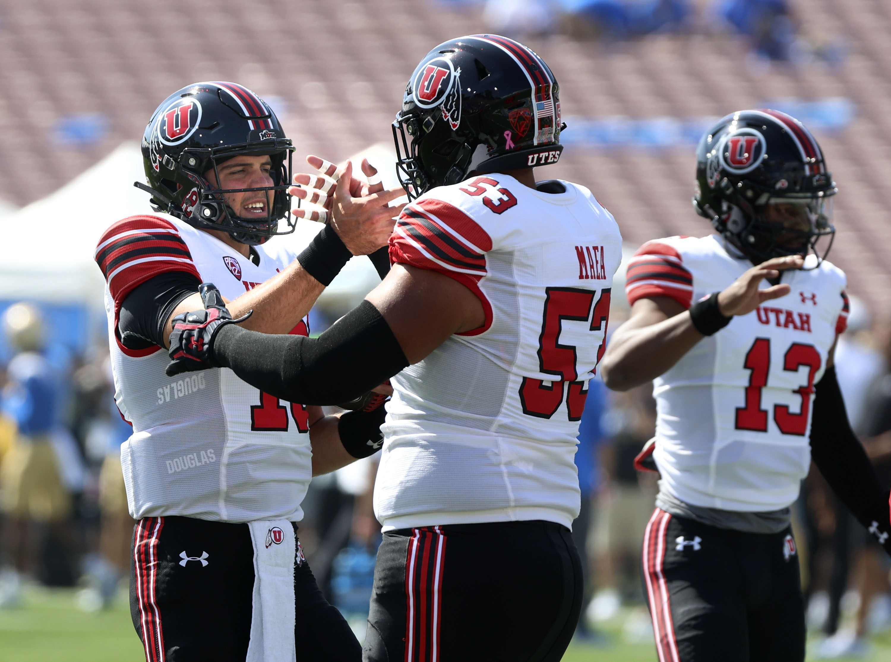 Utes quarterback Bryson Barnes (16) and offensive lineman Johnny Maea (53) get ready for the game against UCLA at the Rose Bowl in Pasadena, CA, on Saturday, Oct. 8, 2022.