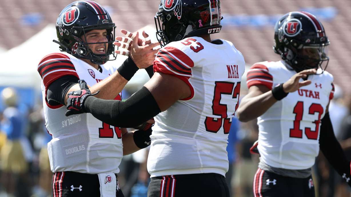 Utes quarterback Bryson Barnes (16) and offensive lineman Johnny Maea (53) get ready for the game against UCLA at the Rose Bowl in Pasadena, CA, on Saturday, Oct. 8, 2022.