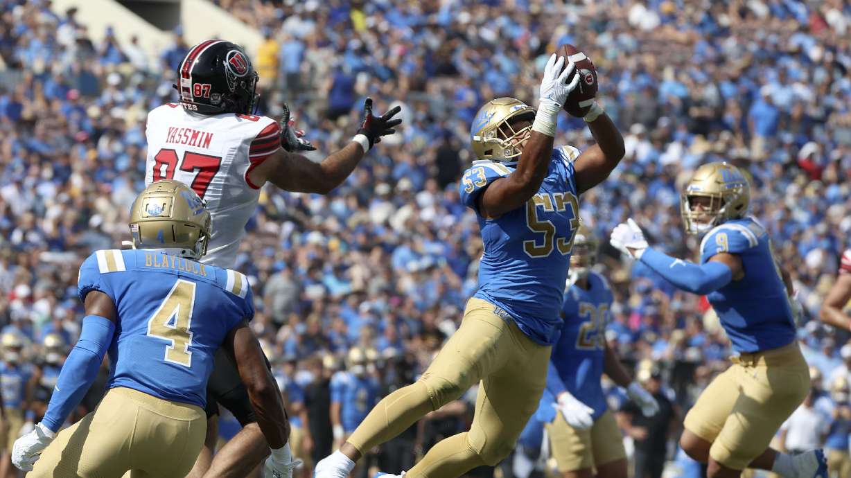 UCLA Bruins linebacker Darius Muasau (53) intercepts a pass intended for Utah Utes tight end Thomas Yassmin (87) at the Rose Bowl in Pasadena, CA, on Saturday, Oct. 8, 2022.