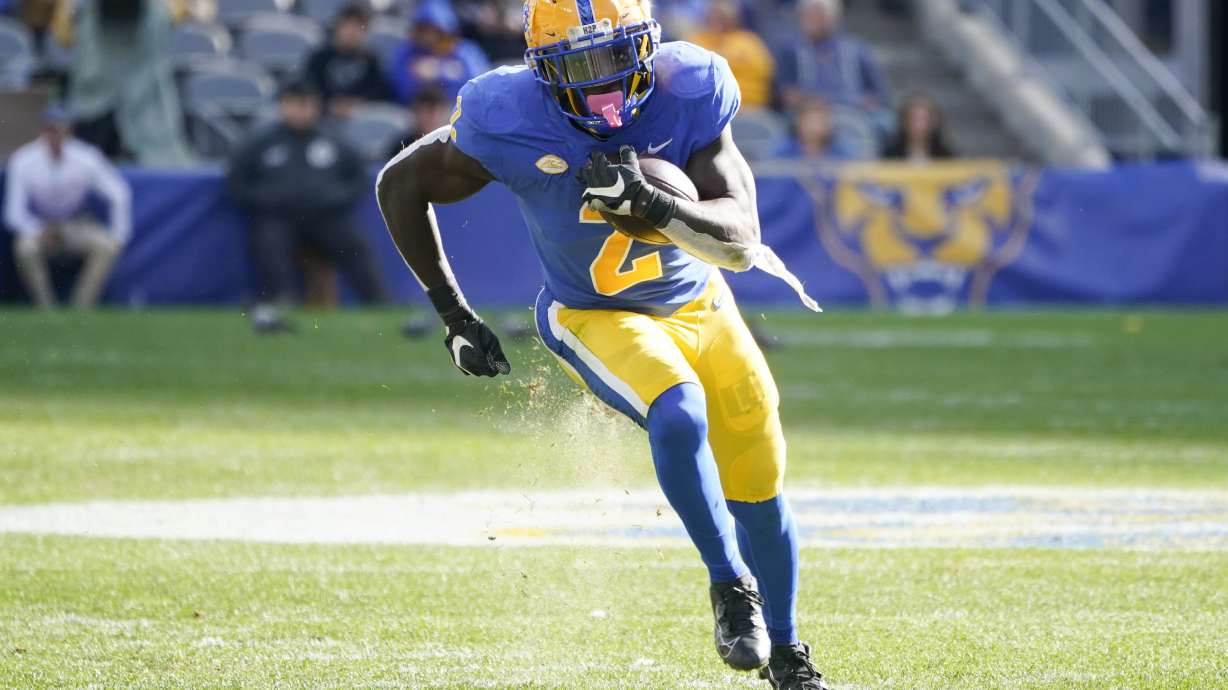 Pittsburgh running back Israel Abanikanda (2) makes a long run for a touchdown against Virginia Tech during the first half of an NCAA college football game, Saturday, Oct. 8, 2022, in Pittsburgh.