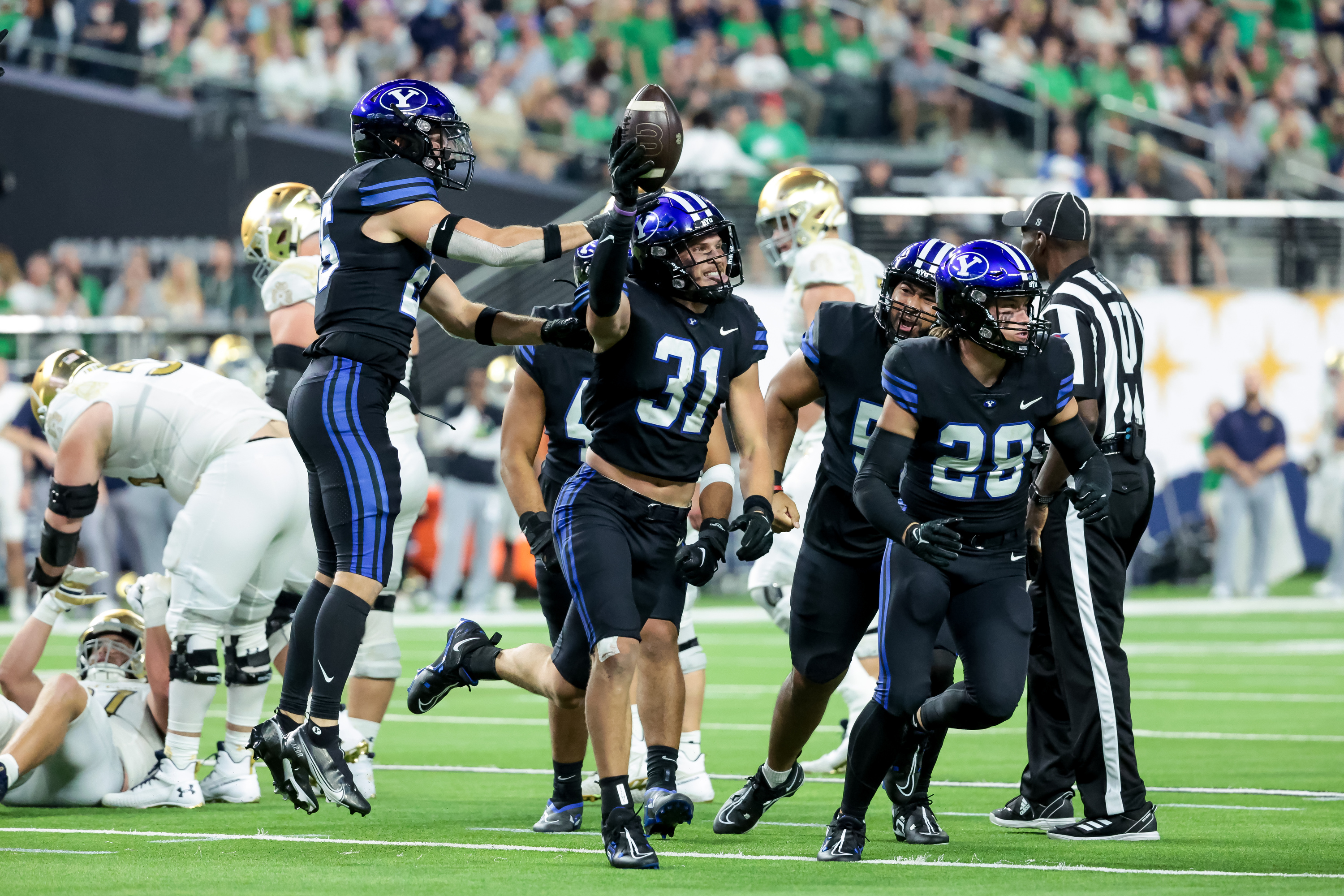 Brigham Young Cougars linebacker Max Tooley (31) celebrates after intercepting a Notre Dame Fighting Irish pass at Allegiant Stadium in Las Vegas on Saturday, Oct. 8, 2022.