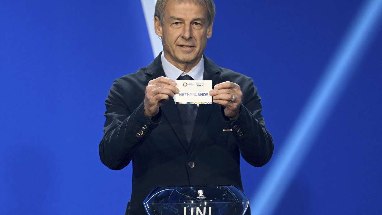 Juergen Klinsmann, former soccer player and soccer official, holds the lot of The Netherlands during the draw for the groups to qualify for the 2024 European soccer championship in Frankfurt, Germany, Sunday, Oct.9, 2022.