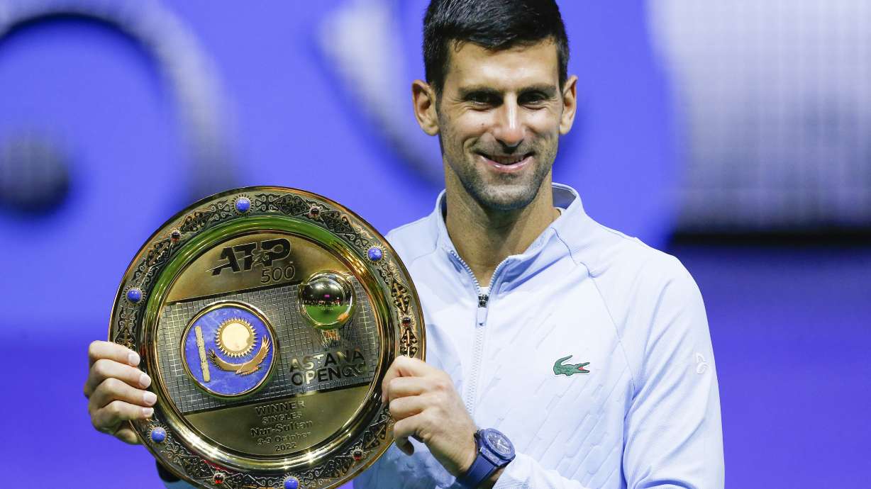 Serbia's Novak Djokovic poses with the trophy after winning the final tennis match of the ATP 500 Astana Open tennis tournament against Stefanos Tsitsipas of Greece in Astana, Kazakhstan, Sunday, Oct. 9, 2022.
