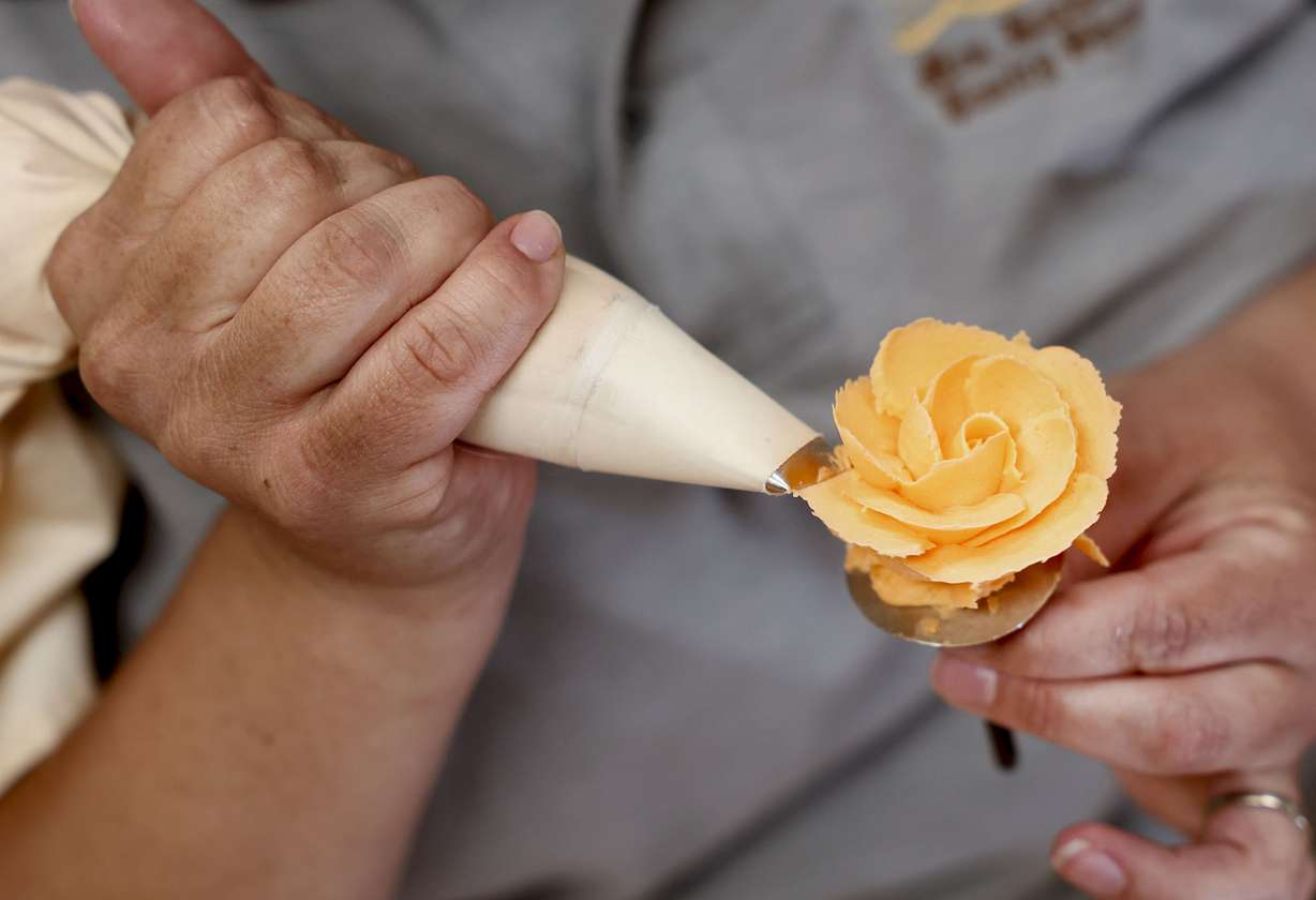 Stefanie Anjewierden creates a rose out of frosting at Backer’s Pastry Shop in Salt Lake City on Wednesday, Sept. 14.