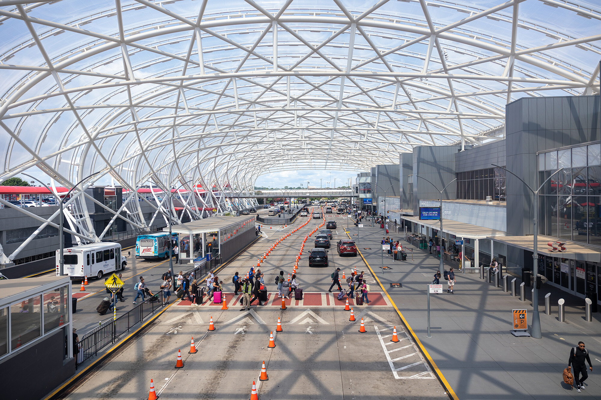 Russian-speaking hackers knock multiple U.S. airport websites offline on Monday. Travelers are here seen going through Hartsfield Jackson International Airport in Atlanta on July 2.