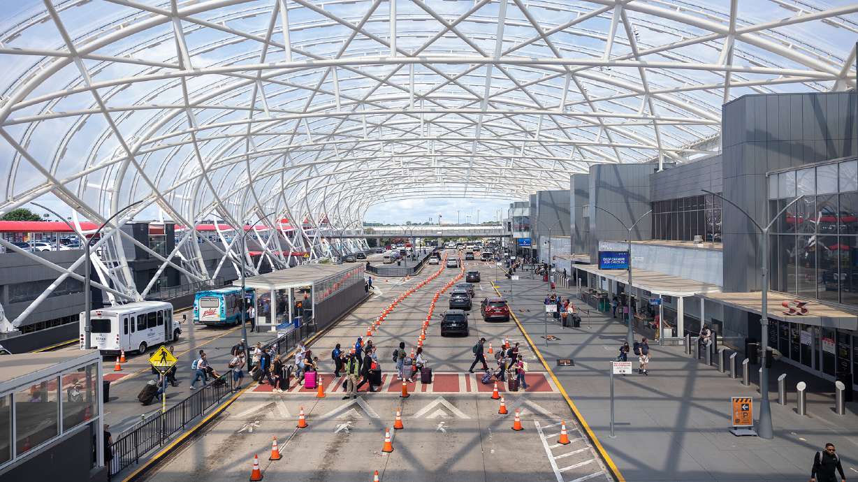 Russian-speaking hackers knock multiple U.S. airport websites offline on Monday. Travelers are here seen going through Hartsfield Jackson International Airport in Atlanta on July 2.