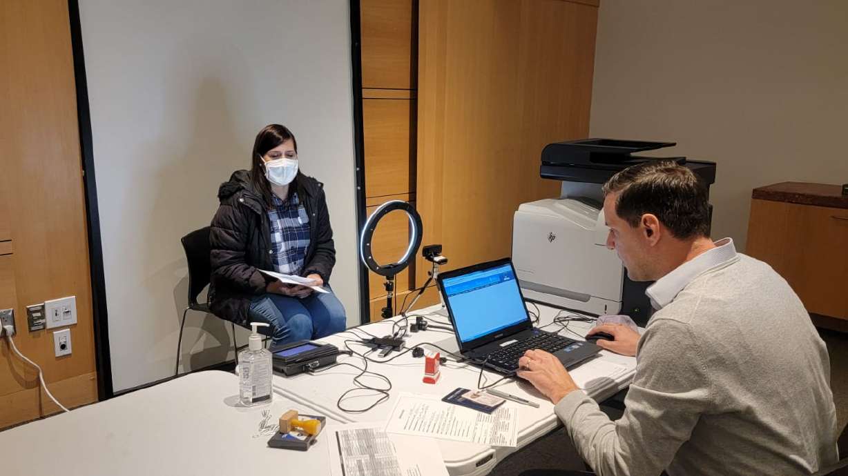 Argentine Deputy Consul Sergio Rojo assists an Argentine citizen during a mobile Argentine Consulate workshop at the Salt Lake City Library.