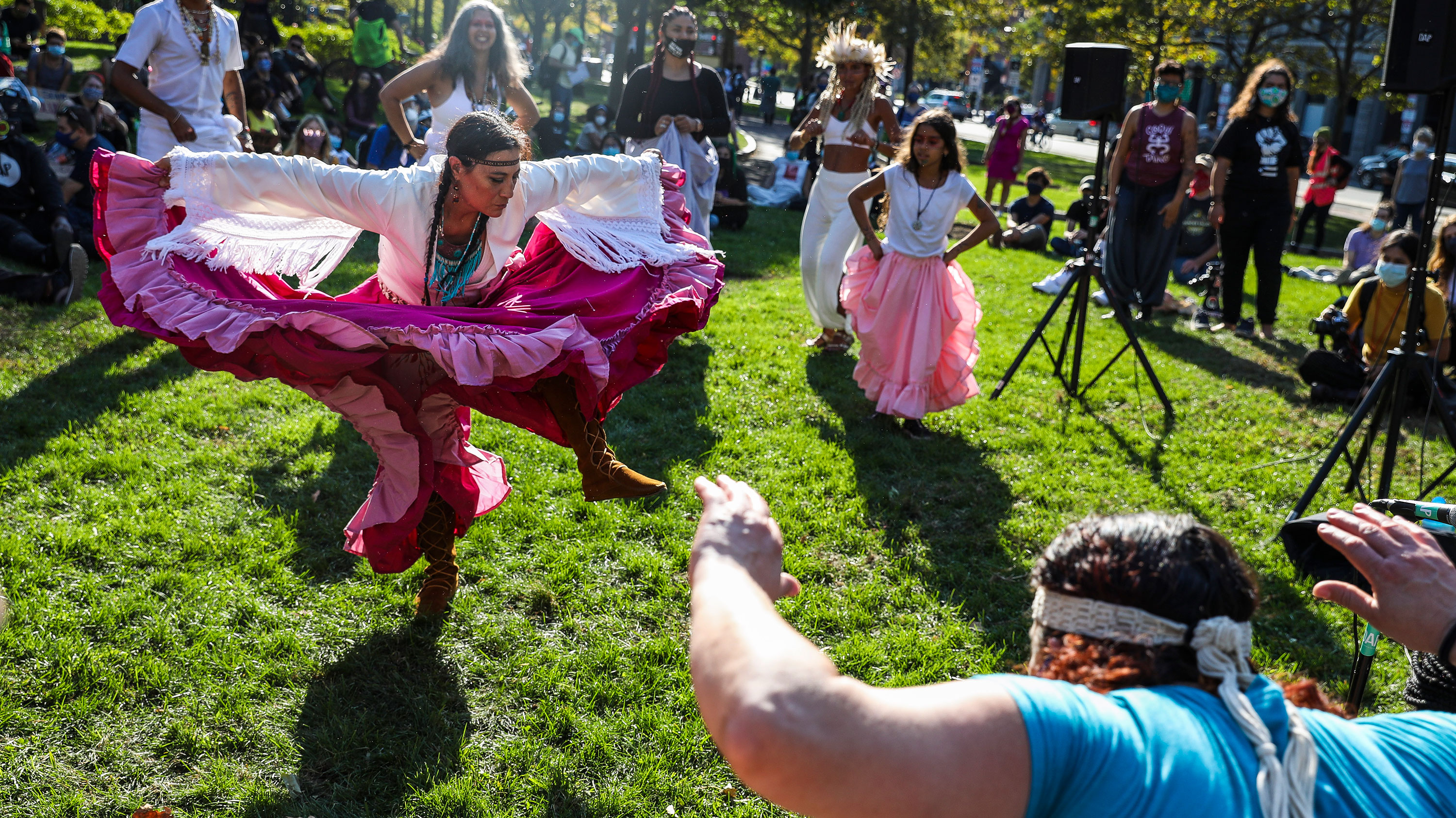 Chali'Naru Dones, with the United Confederation of Taino People, dances in the Christopher Columbus Waterfront Park during the Indigenous Peoples Day rally and march in Boston on Oct. 10, 2020. 