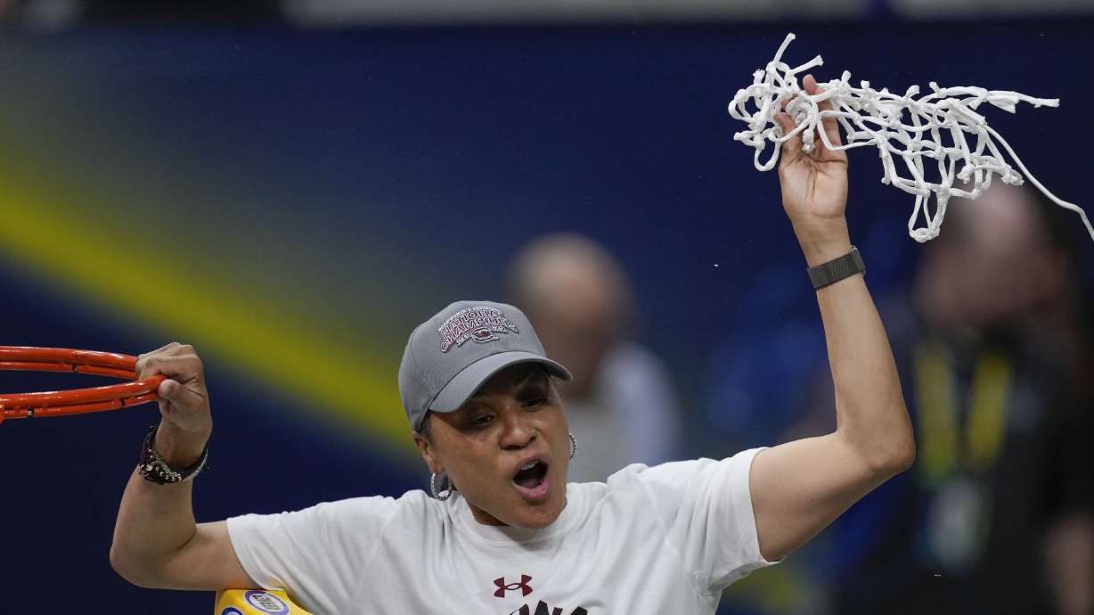 FILE - South Carolina head coach Dawn Staley cuts the net after a college basketball game in the final round of the Women's Final Four NCAA tournament against UConn Sunday, April 3, 2022, in Minneapolis. On Wednesday night, Oct. 12, 2022, Staley will be on the receiving end of more accolades. Staley will accept the Billie Jean King Leadership Award at the Women’s Sports Foundation's Annual Salute to Women in Sports.