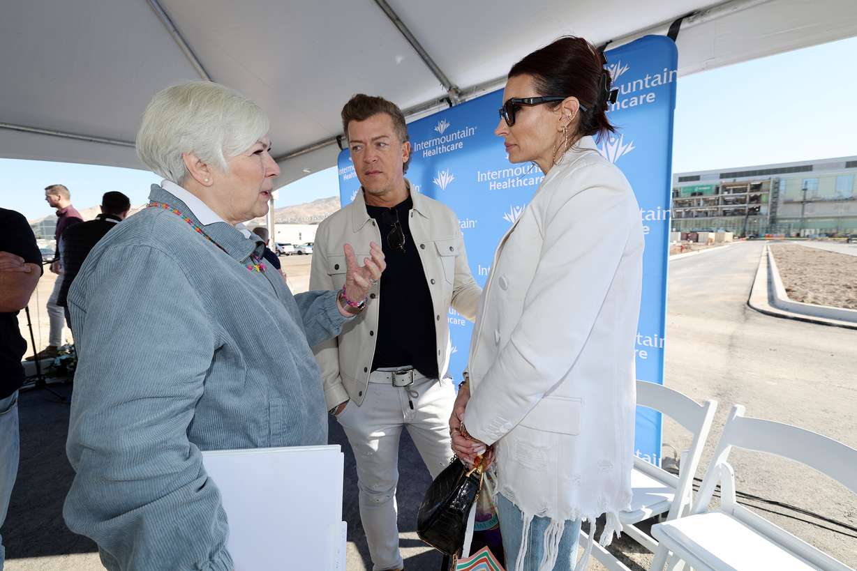 Gail Miller talks with Todd and Andie Pedersen after the announcement that the Pedersens are helping support an initiative to build the nation’s model health system for children on Monday in Lehi.