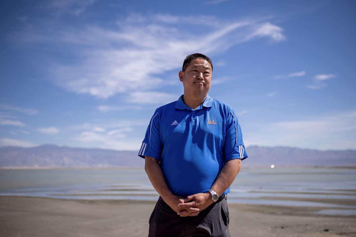 Paul Liu, manager of the Owens Lake Dust Mitigation Program for the Los Angeles Department of Water and Power, talks to journalists in front of a part of the area that holds some water for dust control in Inyo County, Calif., on Aug. 11.