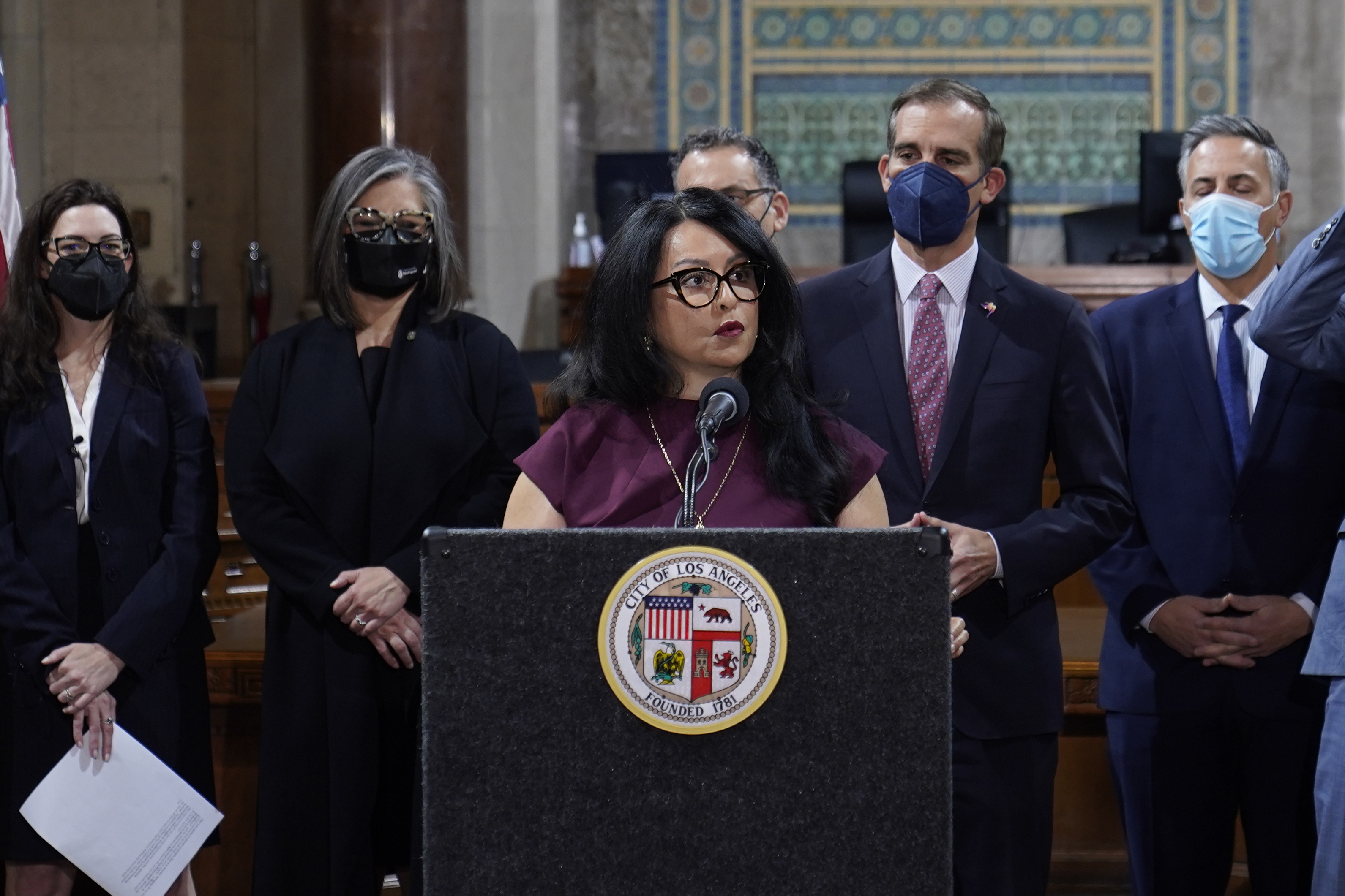 Los Angeles City Council President Nury Martinez at podium, and Mayor Eric Garcetti, standing to her right, are seen during a news conference at Los Angeles City Hall in Los Angeles on April 1. The president of the Los Angeles City Council resigned from the post Monday after she was heard making racist comments and other coarse remarks in a leaked recording of a conversation with other Latino leaders. Council President Nury Martinez issued an apology and expressed shame. 
