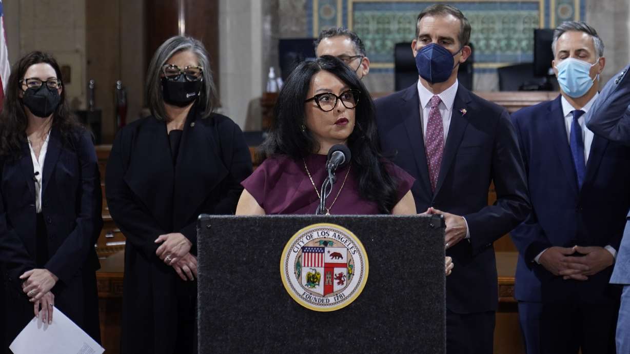 Los Angeles City Council President Nury Martinez at podium, and Mayor Eric Garcetti, standing to her right, are seen during a news conference at Los Angeles City Hall in Los Angeles on April 1. The president of the Los Angeles City Council resigned from the post Monday after she was heard making racist comments and other coarse remarks in a leaked recording of a conversation with other Latino leaders. Council President Nury Martinez issued an apology and expressed shame.