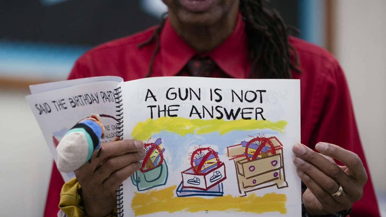 Author Ian Ellis James leads a first grade class in a book reading on urban gun violence prevention at the Drexel Avenue School, Oct. 3 in Westbury, N.Y. As anxiety and depression rates have soared among young Americans, educators and advocates say children’s books can play a role in helping them cope.
