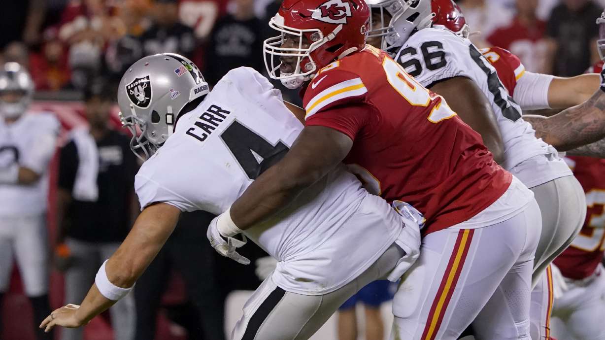 Las Vegas Raiders quarterback Derek Carr (4) is sacked by Kansas City Chiefs defensive tackle Chris Jones, right, during the first half of an NFL football game Monday, Oct. 10, 2022, in Kansas City, Mo.