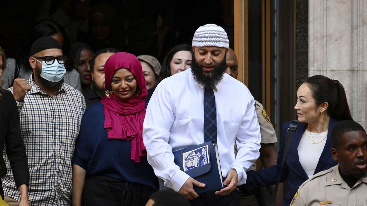 Adnan Syed, center right, leaves the courthouse after a hearing on Sept. 19, in Baltimore. Prosecutors Tuesday dropped charges against Syed in the 1999 killing of Hae Min Lee, a case that was chronicled in the first season of the hit podcast "Serial."
