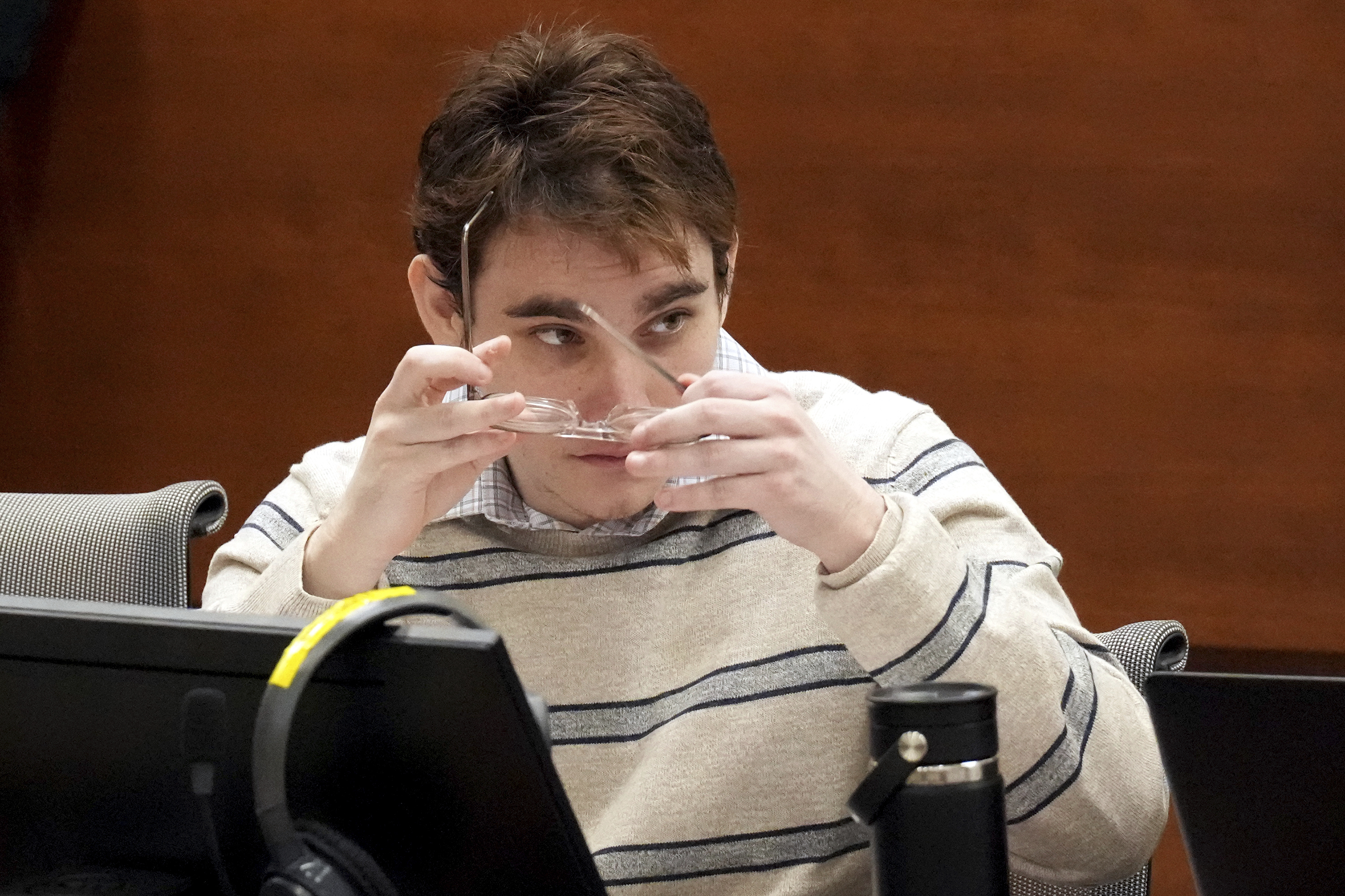 Marjory Stoneman Douglas High School shooter Nikolas Cruz sits at the defense table for closing arguments in the penalty phase of Cruz's trial at the Broward County Courthouse in Fort Lauderdale on Tuesday. Cruz previously plead guilty to all 17 counts of premeditated murder and 17 counts of attempted murder in the 2018 shootings.