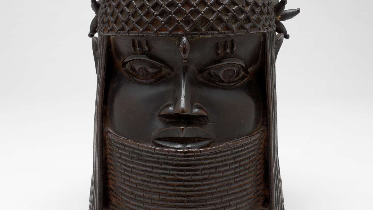 A bronze sculpture called the "Head of a King" or "Oba," probably from the 1700s, rests in front of a white background, December 2004, in Providence, R.I. The sculpture was among 31 culturally precious objects that were looted by the British in the late 19th century and were returned to the Nigerian government, Oct. 11.