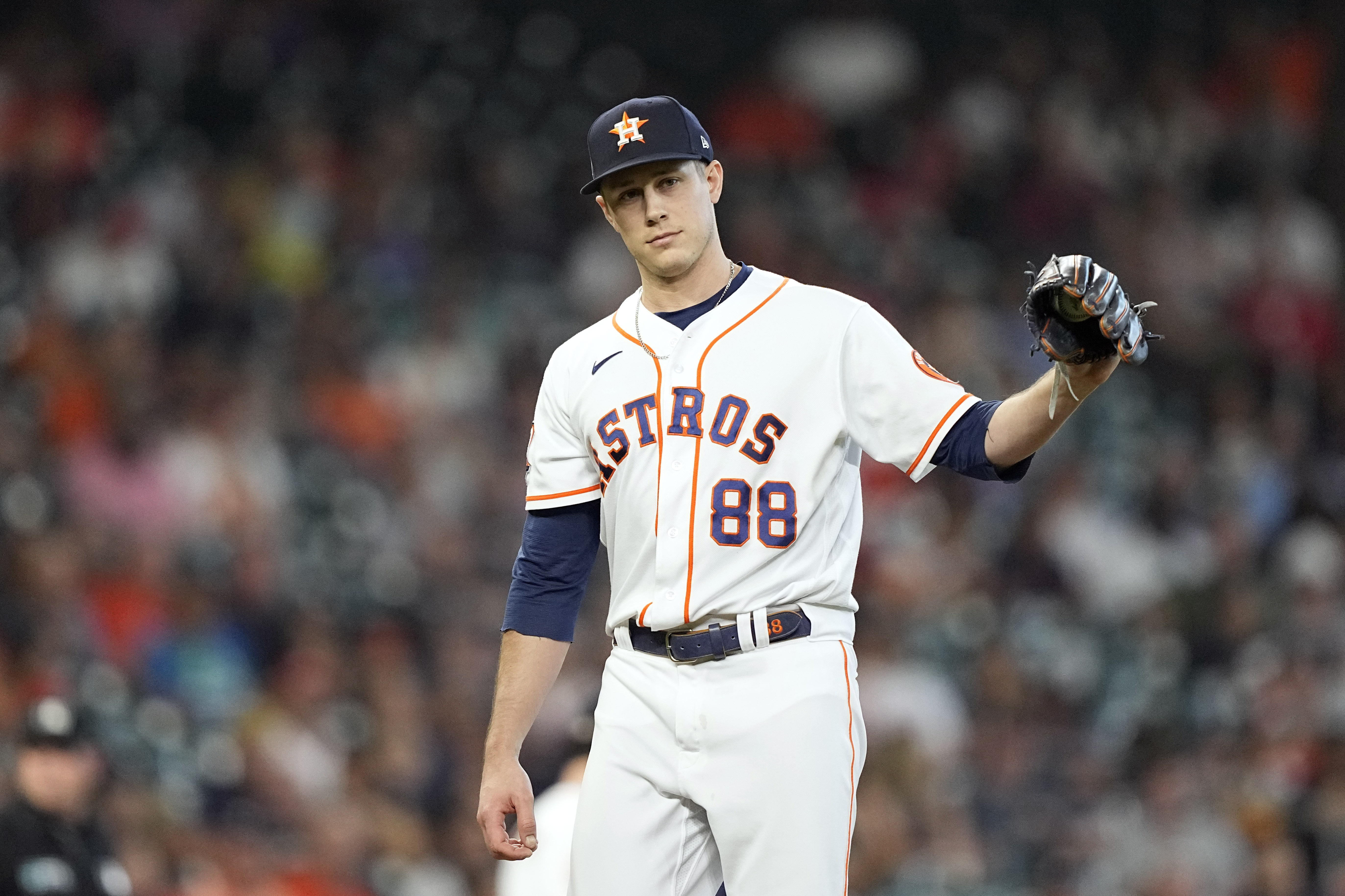 Houston Astros relief pitcher Phil Maton looks toward first base after giving up a single to his brother, Philadelphia Phillies Nick Maton, during the eighth inning of a baseball game Wednesday, Oct. 5, 2022, in Houston. 