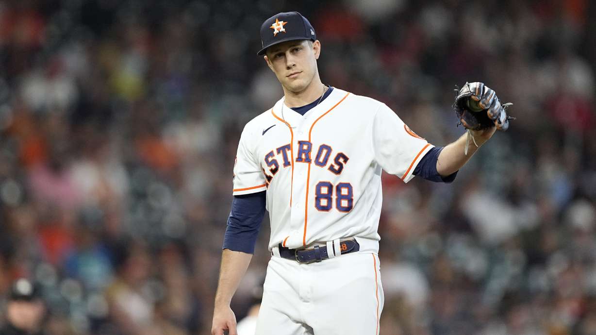 Houston Astros relief pitcher Phil Maton looks toward first base after giving up a single to his brother, Philadelphia Phillies Nick Maton, during the eighth inning of a baseball game Wednesday, Oct. 5, 2022, in Houston.