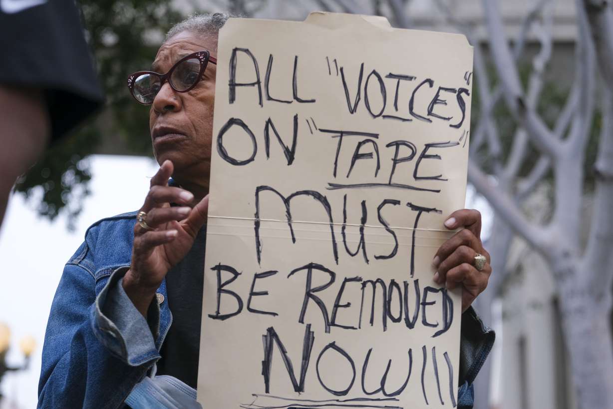 Veronica Sance holds a sign in a news conference to denounce racism and demand change in response to a recorded, racially charged leaked conversation between leaders at City Hall and the Los Angeles County Federation of Labor President, before the Los Angeles City Council meeting outside city hall, Tuesday in Los Angeles .